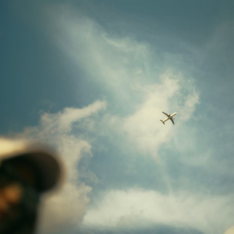 An aeroplane crossing a break in the clouds