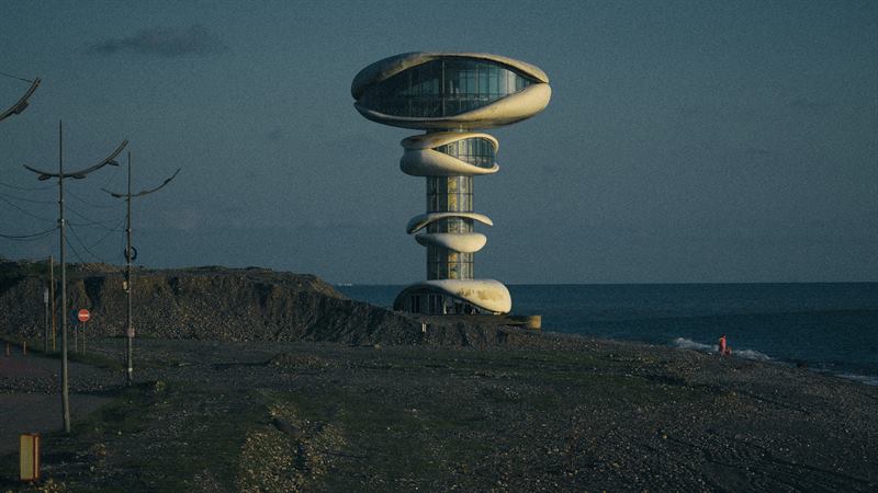 The abandoned spiral tower on the shore at Anaklia, Georgia, the pebble beach empty in the evening